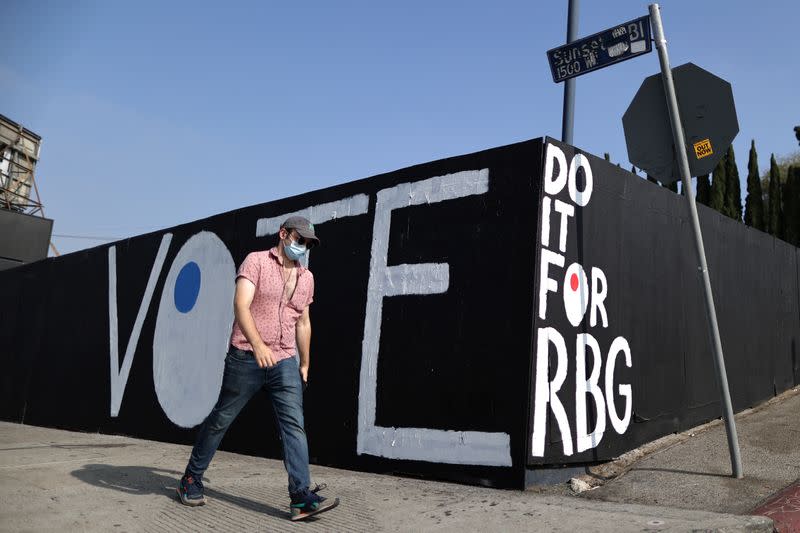 A man walks past a tribute mural to the late Justice Ruth Bader Ginsburg in Los Angeles