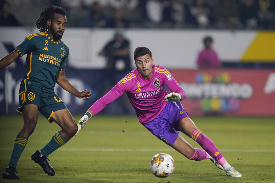 LA Galaxy goalkeeper Jonathan Bond, right, dives for the ball past defender Raheem Edwards during the first half of the team's MLS soccer match against Minnesota United, Wednesday, Sept. 20, 2023, in Carson, Calif. (AP Photo/Ryan Sun)