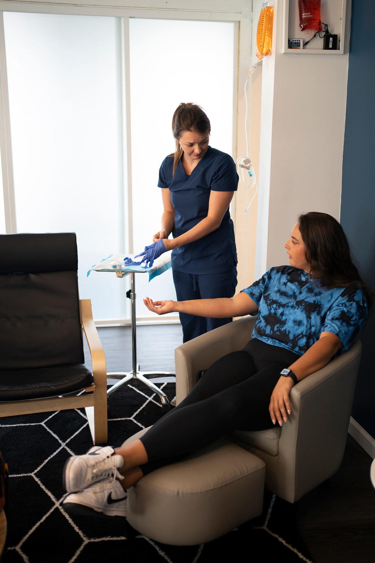 Nurse Tori Hymiller prepares to put a "Refresh" IV in Andrea Spencer, 29, at Wellness Flow, a new IV therapy studio that opened in the Short North in July.