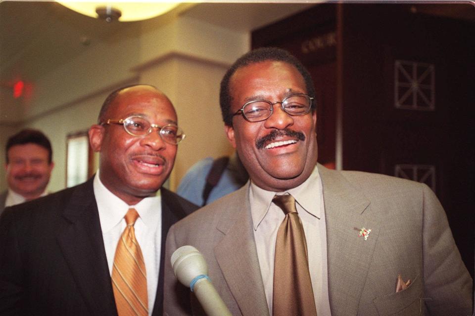 Attorneys Willie Gary, left, and Johnnie Cochran, greet reporters in 2000 after the pair successfully represented All Pro Sports Camps in their lawsuit against Disney. A new movie, "The Burial," looks at a 1995 case won by Gary, and hints at a rivalry between the two.