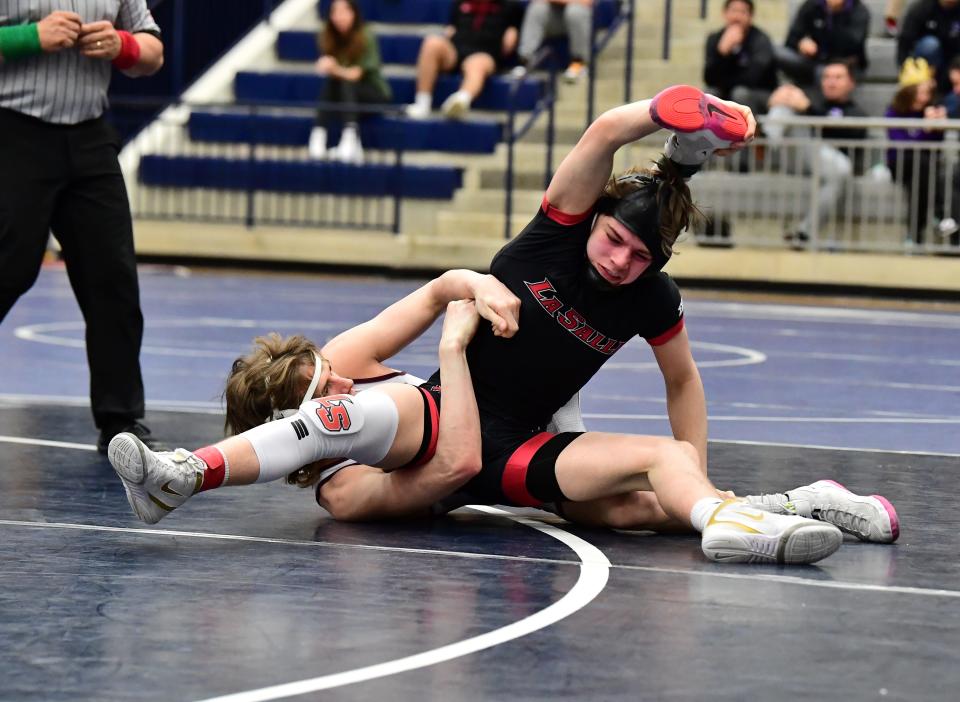 La Salle's Holden Huhn grapples with Jack McCall of Lebanon in the title bout at 132 pounds at the Division I Southwest District boys wrestling championships in Kettering, Ohio, March 4, 2023.