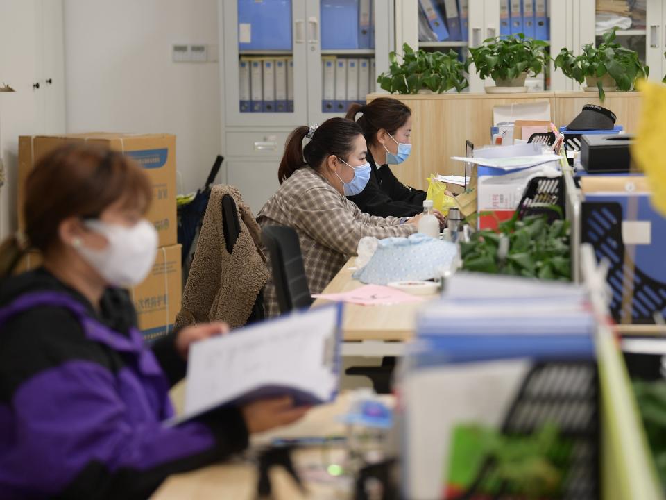 Staff members work in the office at a vegetable planting base in Chongming District, east China's Shanghai, April 19, 2022.