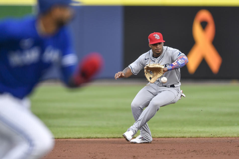 Tampa Bay Rays shortstop Wander Franco, right, fields a ground ball and forces out Toronto Blue Jays' Reese McGuire at second on a hit by Marcus Semien, who was safe at first after a challenge, during the second inning of a baseball game in Buffalo, N.Y., Friday, July 2, 2021. (AP Photo/Adrian Kraus)