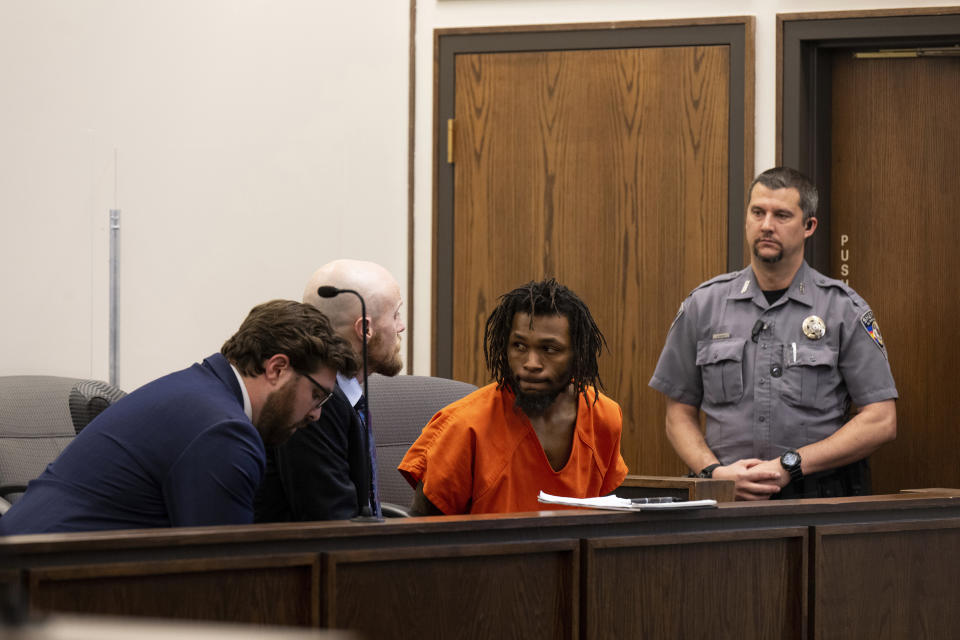 Nicholas Jordan, center right, speaks with his legal counsel during his first appearance at the El Paso County Combined Courts on Friday, Feb. 23, 2024, in Colorado Springs Colo. Jordan was arrested Monday in the deaths of his roommate, 24-year-old, Samuel Knopp, and Celie Rain Montgomery, at the University of Colorado Colorado Springs. (Parker Seibold/The Gazette via AP, Pool)