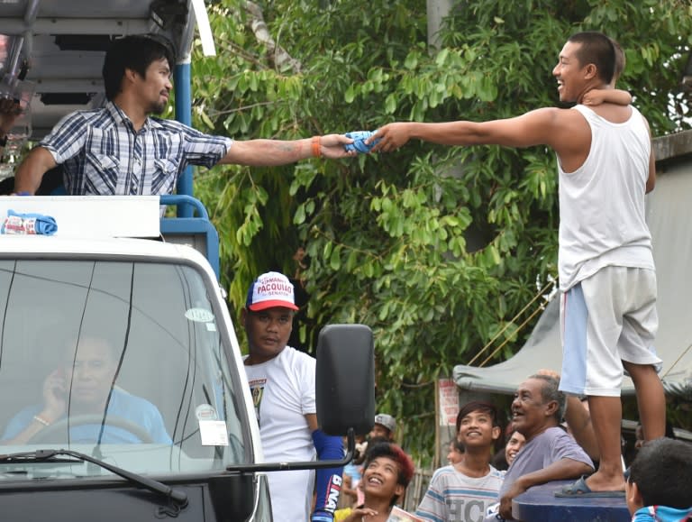 Boxing legend Manny Pacquiao smiles as he soaks up the sounds of adoring fans screaming his name, their cheers heralding a new career as one of the Philippines' most powerful politicians