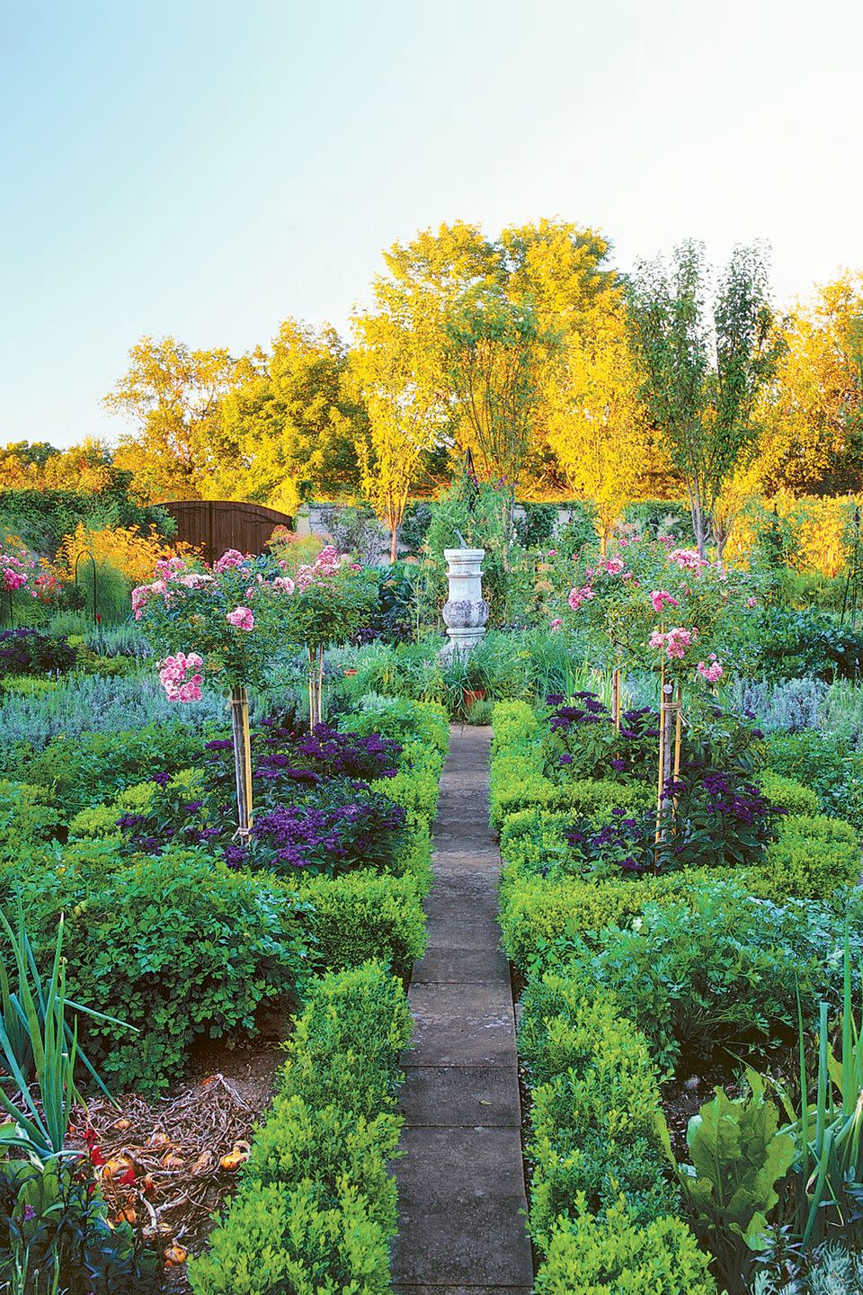 <p>Flowers are sprinkled throughout this Connecticut garden, from the bold prelude—a moody row of rose and clematis arbors—to herb beds anchored in 'Fairy' rose standards rising above fragrant heliotrope. The homeowner also devoted ample space for purple basil beside sweet, jalapeno, and paprika peppers.<br></p>