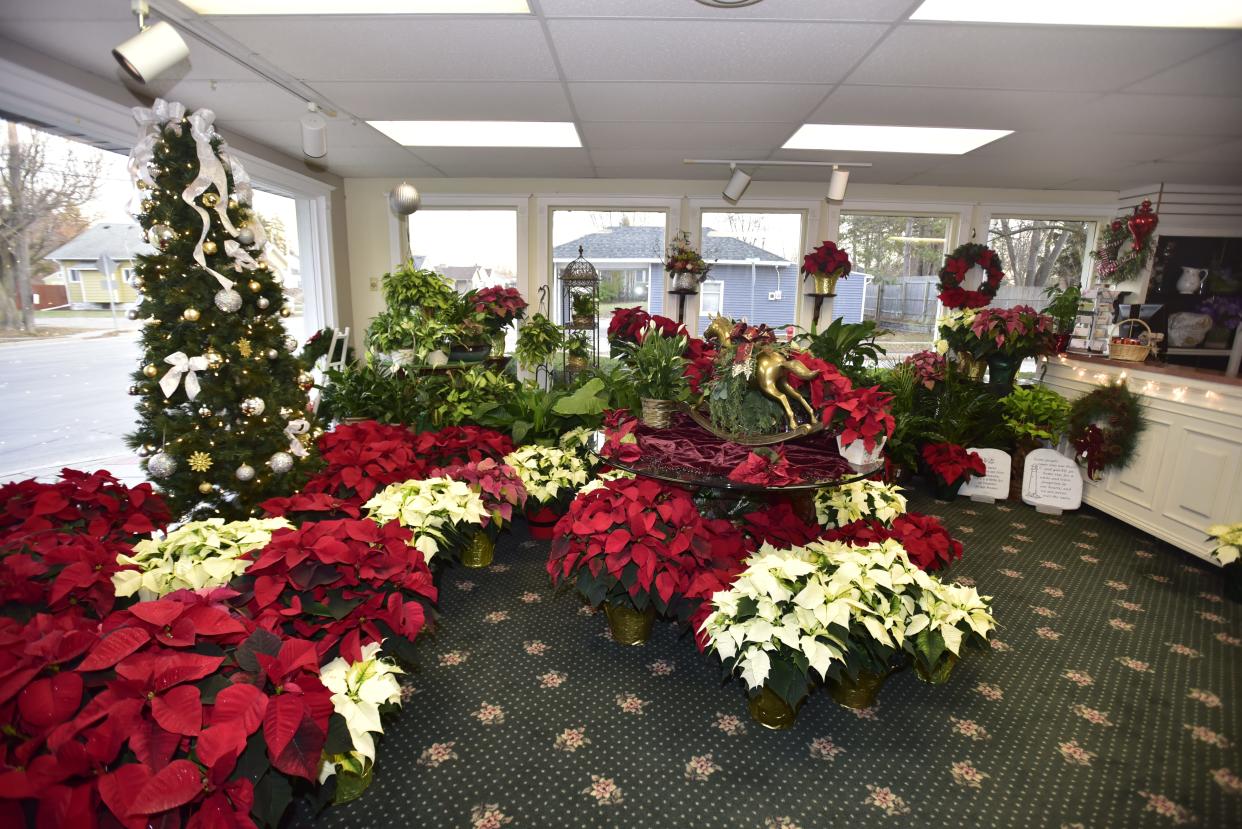 Christmas flower arrangements and decorations on display inside the Flower Niche shop located 1902 Water St., in Port Huron, on Tuesday, Nov. 22, 2022.