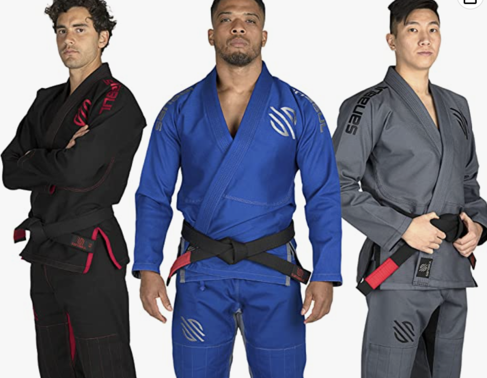 Three men wear different coloured BJJ gi.