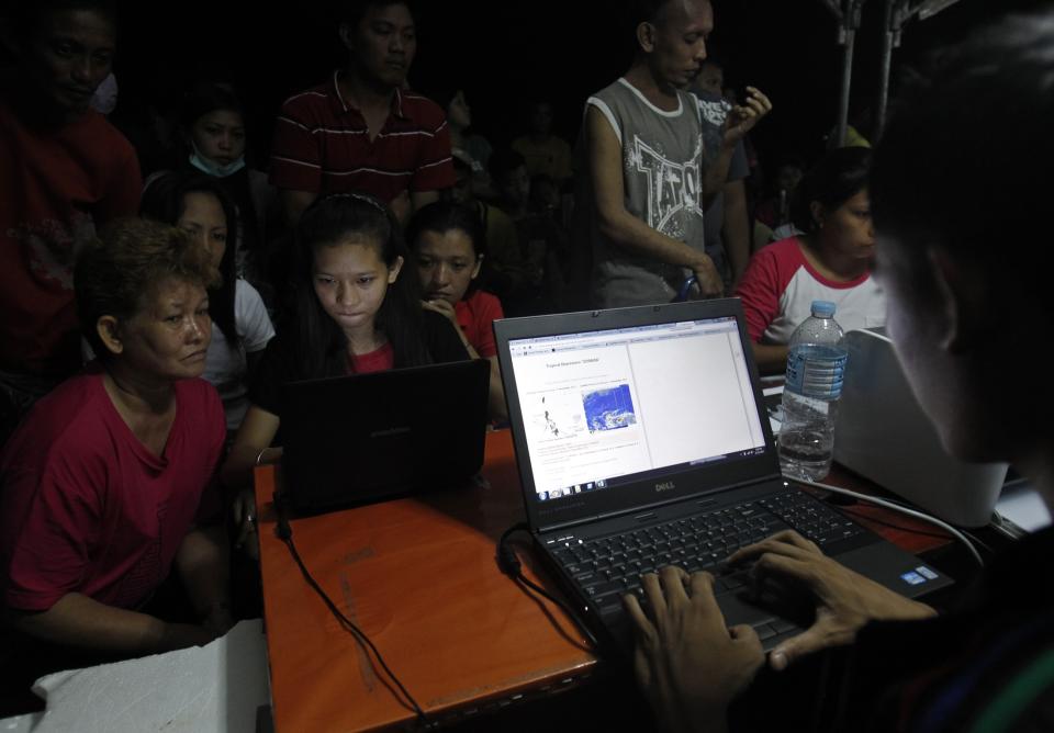 Enriquez helps her mother inform their family in Manila of their situation using Facebook after the Super typhoon Haiyan battered Tacloban city in central Philippines