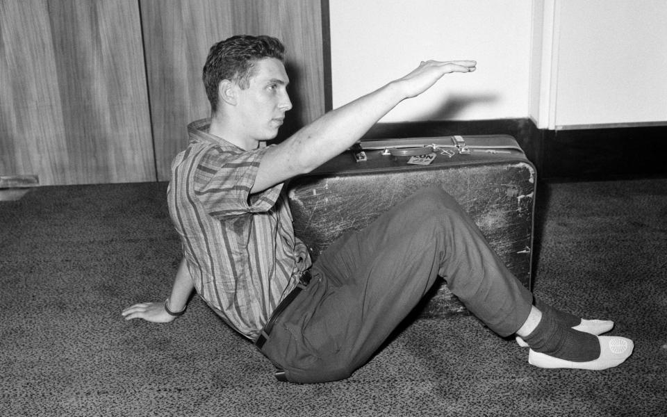 Brian shows how he sat with his suitcase in the packing case. 18th May 1965. - Daily Mirror /Tom King 