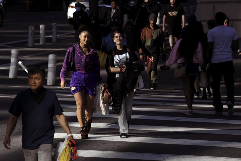 Pedestrians make their way through the streets of downtown Los Angeles