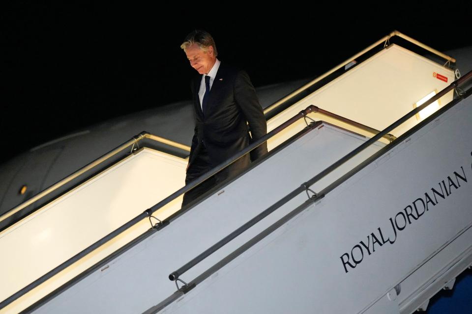 A photo of Antony Blinken exiting a plane.