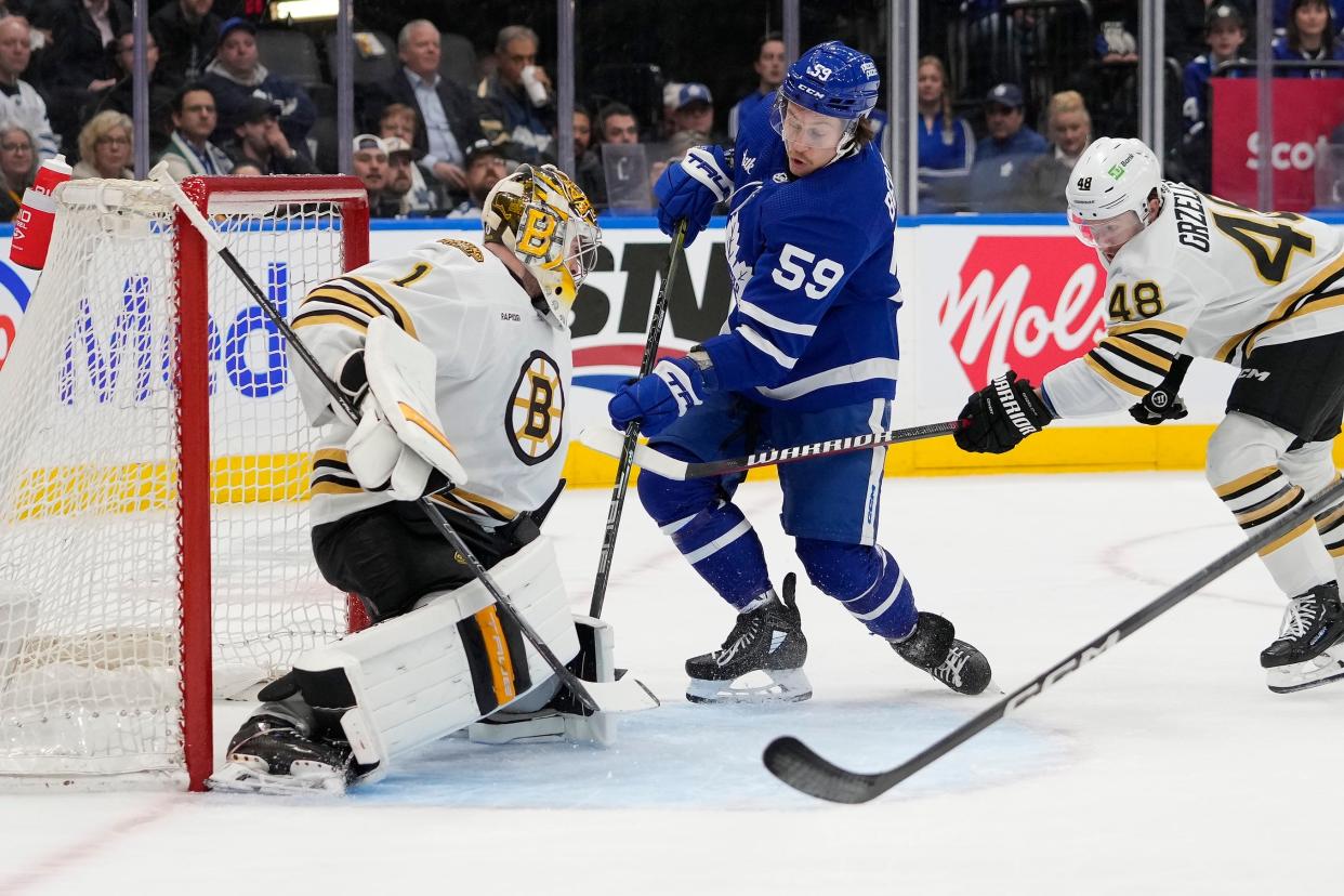 Boston Bruins goaltender Jeremy Swayman (1) makes a save on Toronto Maple Leafs forward Tyler Bertuzzi (59).