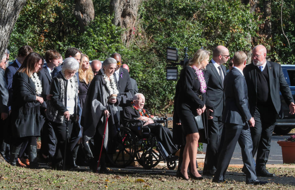 Nov 29, 2023; Plains, GA, USA; Family members surround former President Jimmy Carter as they walk to the entrance of Maranatha Baptist Church for the funeral service for former first lady Rosalynn Carter. Rosalynn Carter died Sunday, Nov. 19, 2023 at her home in Plains, Ga. at the age of 96.. Mandatory Credit: Richard Burkhart-USA TODAY