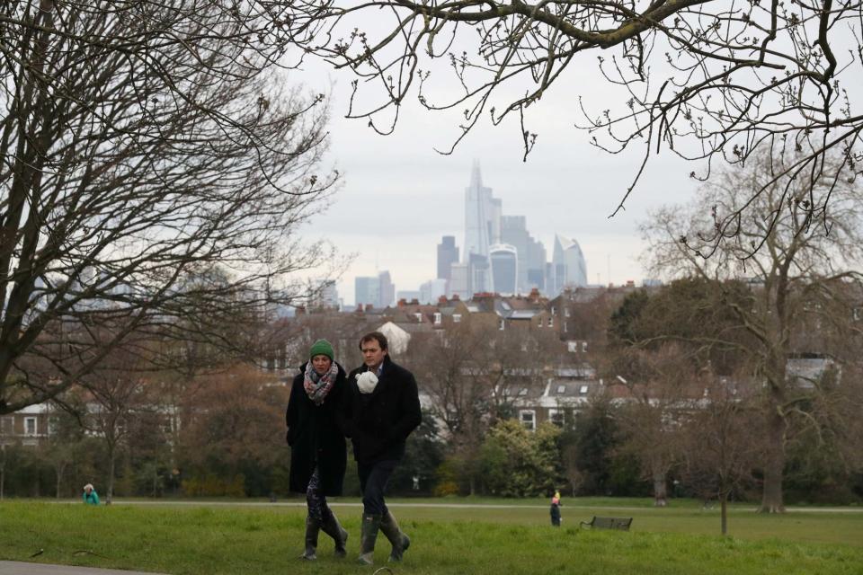 Walkers enjoy the park last week, when the weather was considerably cooler (REUTERS)