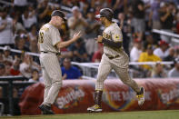 San Diego Padres' Trent Grisham, right, celebrates his three-run home run with third base coach Matt Williams (18) during the fifth inning of the team's baseball game against the Washington Nationals, Friday, Aug. 12, 2022, in Washington. (AP Photo/Nick Wass)