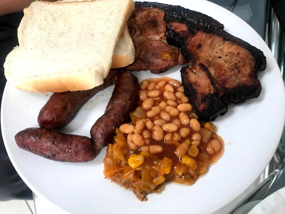 Typical South African braai food of chops, broewors, bread or rolls, and baked beans