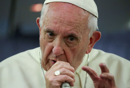 Pope Francis gestures during a news conference on board of the plane during his flight back from a trip to Chile and Peru, January 22, 2018. REUTERS/Alessandro Bianchi