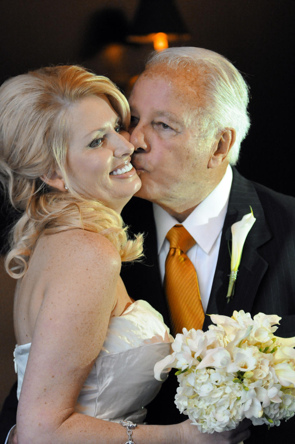 FILE - In this July 29, 2011, file photo, former Governor Edwin Edwards, right, kisses his new bride, Trina Grimes Scott, after a ceremony in the French Quarter in New Orleans, La. Edwin Washington Edwards, the high-living four-term governor whose three-decade dominance of Louisiana politics was all but overshadowed by scandal and an eight-year federal prison stretch, died Monday, July 12, 2021 . He was 93. Edwards died of respiratory problems with family and friends by his bedside, family spokesman Leo Honeycutt said. He had suffered bouts of ill health in recent years and entered hospice care this month at his home in Gonzales, near the Louisiana capital. (AP Photo/Cheryl Gerber, File)