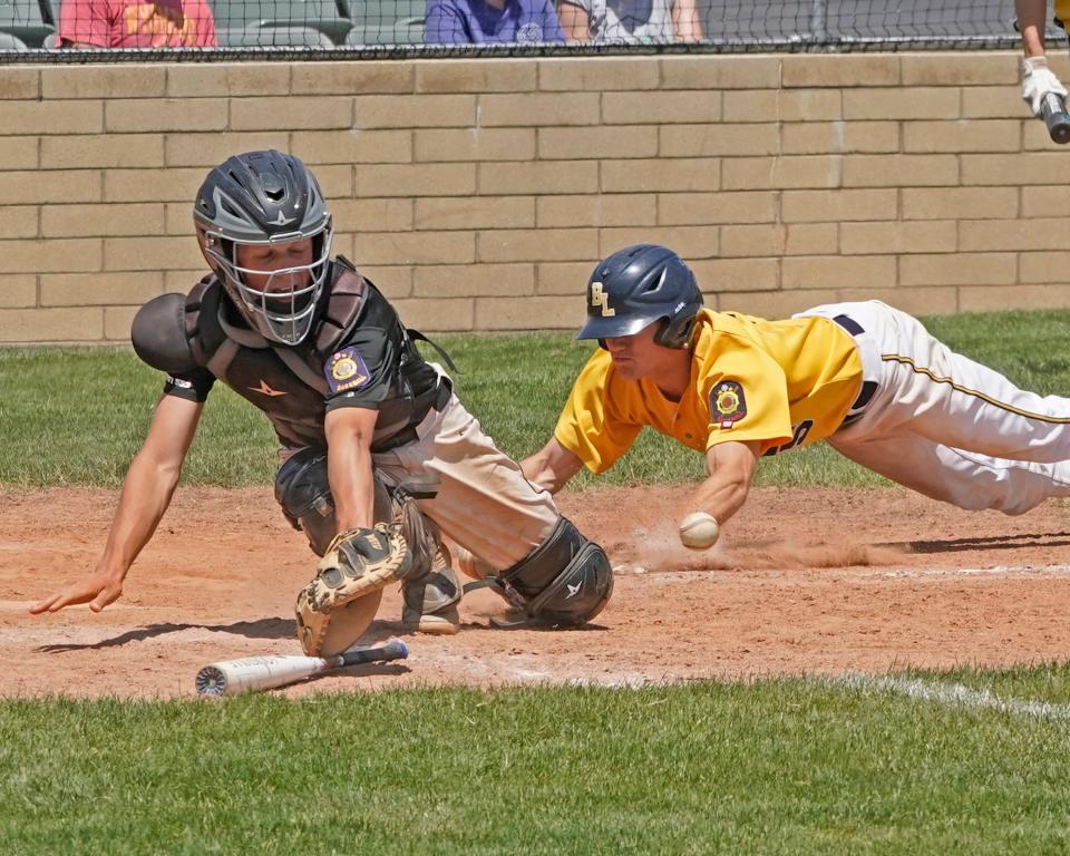 Blissfield's Brenden Holland slides into home for a run for Post 325 Sunday during the Blissfield Tournament championship game against the Toledo Hawks.