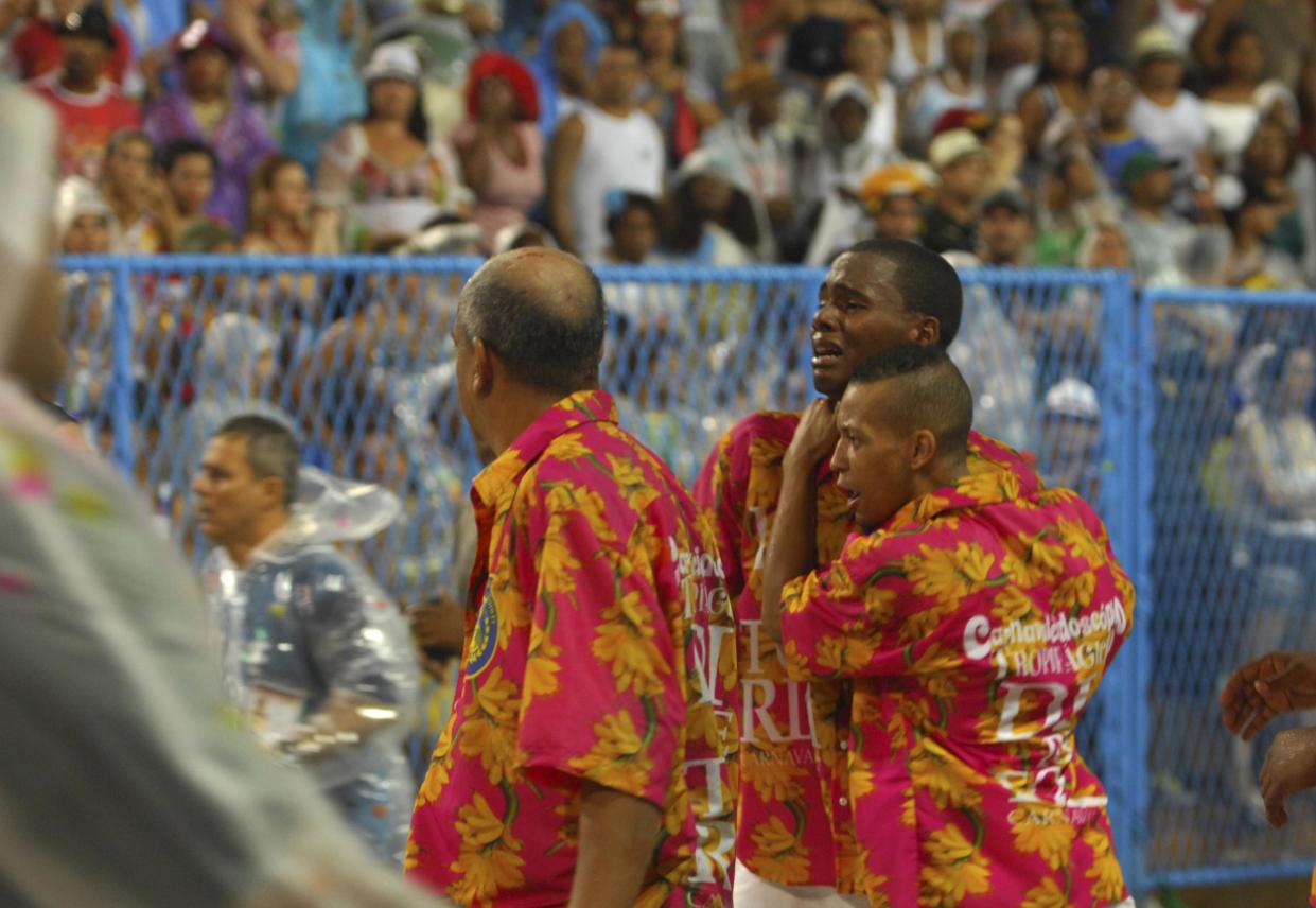 Devastated: Members of the Paraiso de Tuiuti samba school react after a float crash during Carnival celebrations at the Sambadrome in Rio de Janeiro: AP