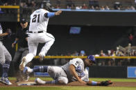 Arizona Diamondbacks' Stephen Vogt (21) hits a single by beating Los Angeles Dodgers first baseman Albert Pujols, right, to the base in the eighth inning during a baseball game, Sunday, June 20, 2021, in Phoenix. (AP Photo/Rick Scuteri)