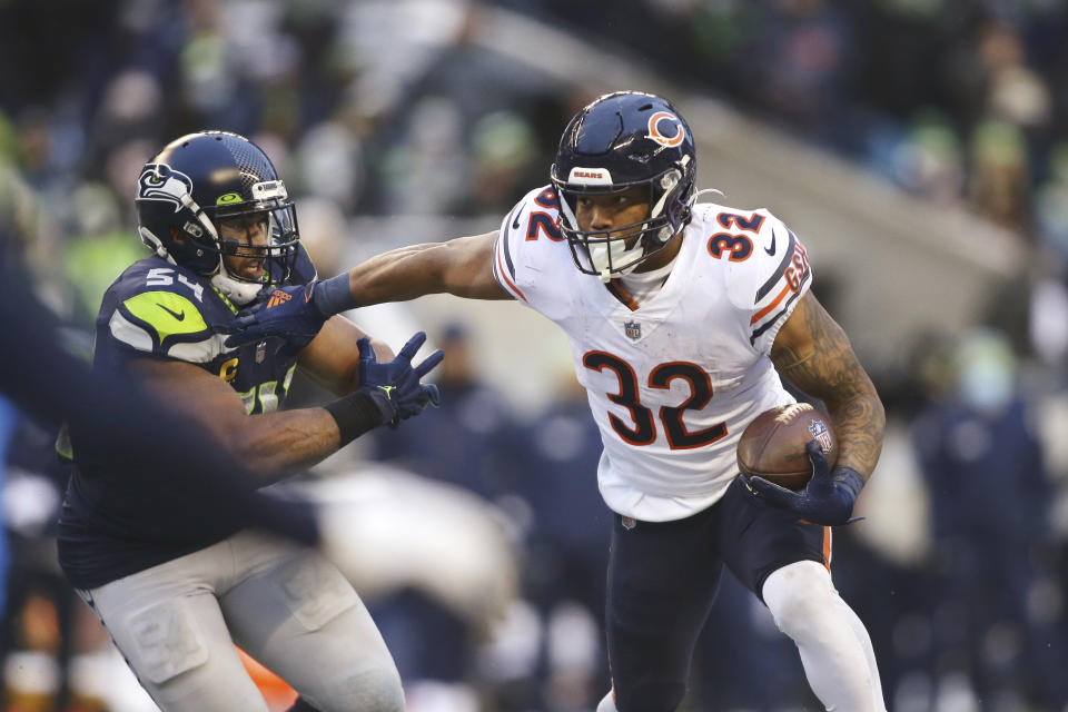 Chicago Bears running back David Montgomery (32) carries as Seattle Seahawks' Bobby Wagner moves in during the second half of an NFL football game, Sunday, Dec. 26, 2021, in Seattle. (AP Photo/Lindsey Wasson)