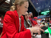 Jayme Hoskins, front, wife of Philadelphia Phillies first baseman Rhys Hoskins, pays for beers she purchased for fans before Game 4 of the baseball World Series between the Phillies and the Houston Astros on Wednesday. Nov. 2, 2022, in Philadelphia. Hoskins tweeted she would buy fans beer before the game at Section 104 of the stadium. She bought about 100 beers. (AP Photo/Daniel Gelston)