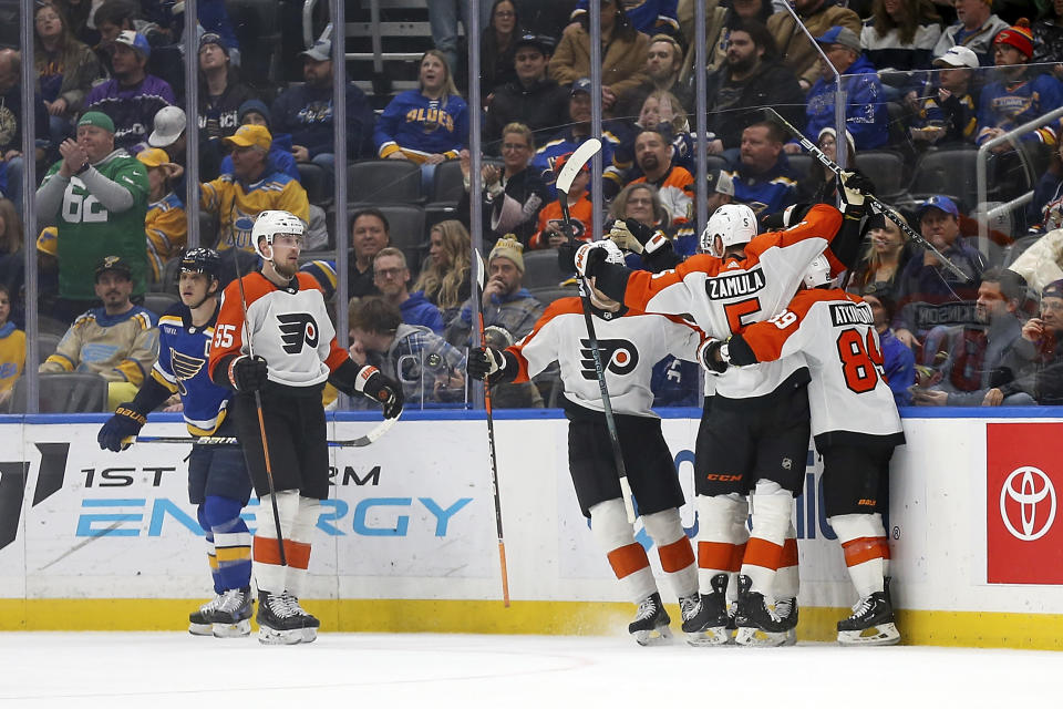 Members of the Philadelphia Flyers celebrate after scoring a goal during the second period of an NHL hockey game against the St. Louis Blues, Monday, Jan. 15, 2024, in St. Louis. (AP Photo/Scott Kane)