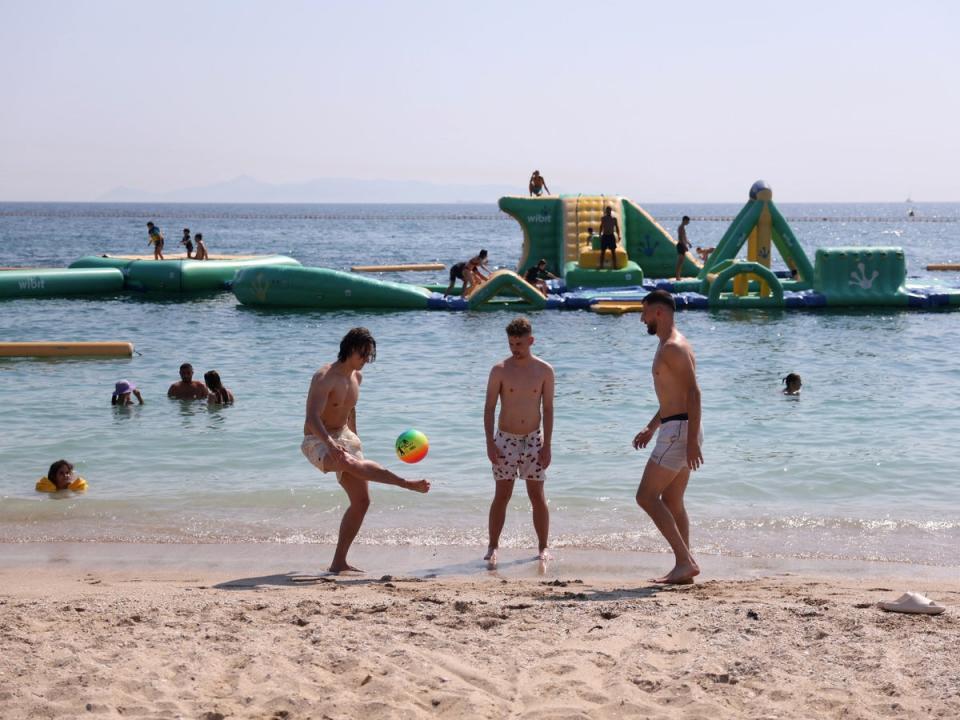 Holidaymakers on Alimos beach, near Athens (Louiza Vradi/Reuters)