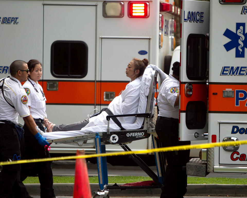 <p>A woman, who exited the Marco Polo apartment complex, is placed in an ambulance as firefighters continue to battle the blaze at the high-rise, Friday, July 14, 2017, in Honolulu, Hawaii. (Photo: Marco Garcia/AP) </p>