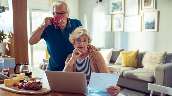 A woman reviews her retirement plan documents to determine whether she should make a lump sum or a series of monthly payments.