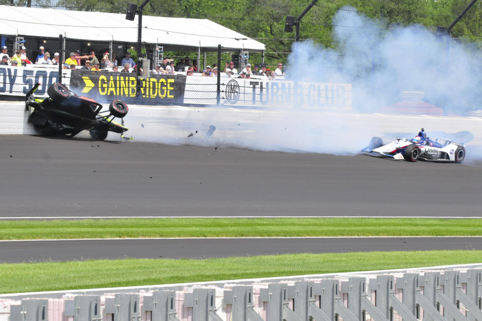 Sebastien Bourdais, of France, hits the wall in the third turn after making contact with Graham Rahal, right, during the Indianapolis 500 IndyCar auto race at Indianapolis Motor Speedway, Sunday, May 26, 2019, in Indianapolis. (AP Photo/James Miller)