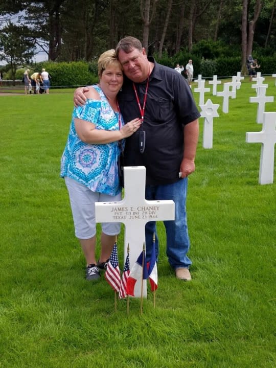 <em>Cousins Robbie Brandehoff (left) and Greg Chaney (right) at James E. Chaney’s burial site (Normandy American Cemetery, Normandy France, 2018)</em>