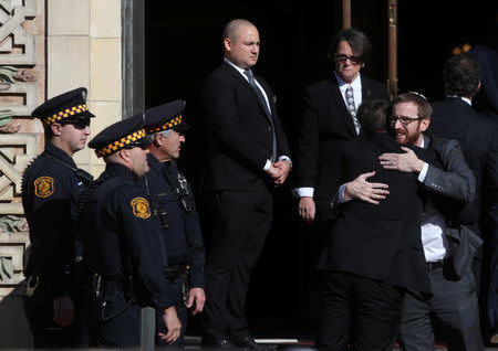 Mourners embrace after arriving for funeral services for brothers Cecil and David Rosenthal, victims of the Tree of Life Synagogue shooting, at the entrance to Rodef Shalom Temple in Pittsburgh, Pennsylvania, U.S., October 30, 2018. REUTERS/Cathal McNaughton