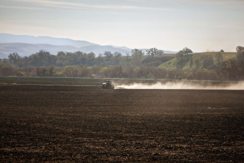 A tractor plows a field as Valley Fever, a fungal infection that spreads through dust