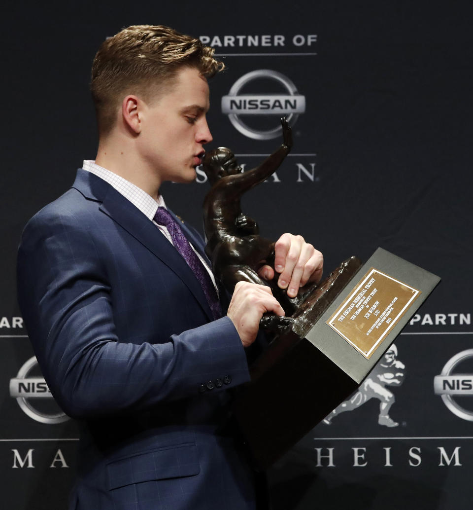 NCAA college football player, LSU quarterback Joe Burrow poses for a photo after winning the Heisman Trophy, Saturday, Dec. 14, 2019 in New York. (AP Photo/Jason Szenes)