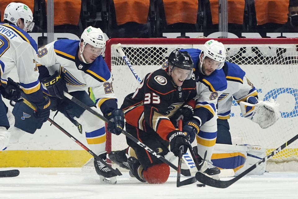 Anaheim Ducks right wing Jakob Silfverberg (33) is defended by St. Louis Blues defenseman Marco Scandella (6) and defenseman Vince Dunn (29) during the first period of an NHL hockey game Wednesday, March 3, 2021, in Anaheim, Calif. (AP Photo/Marcio Jose Sanchez)