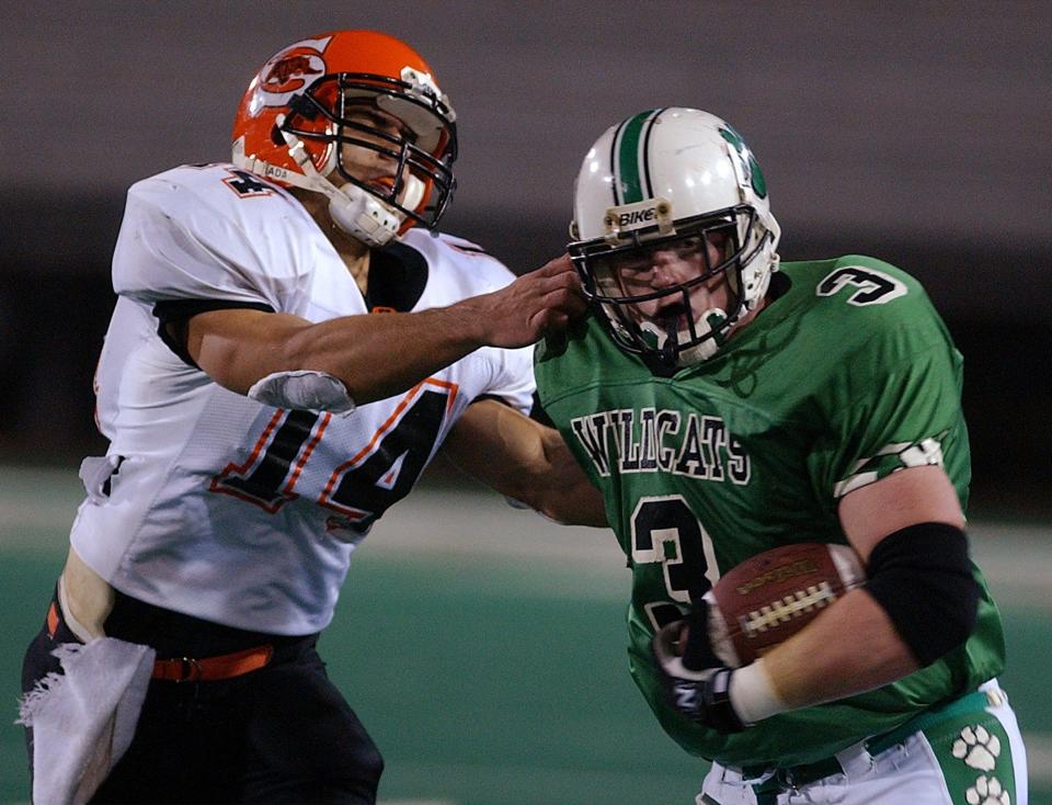 Shadyside's Mike Kernik tries to catch Mogadore's Tommy Lee in a Division VI playoff game on Nov. 24, 2001. Tommy Lee is the uncle of Hoban star linebacker Eli Lee.
