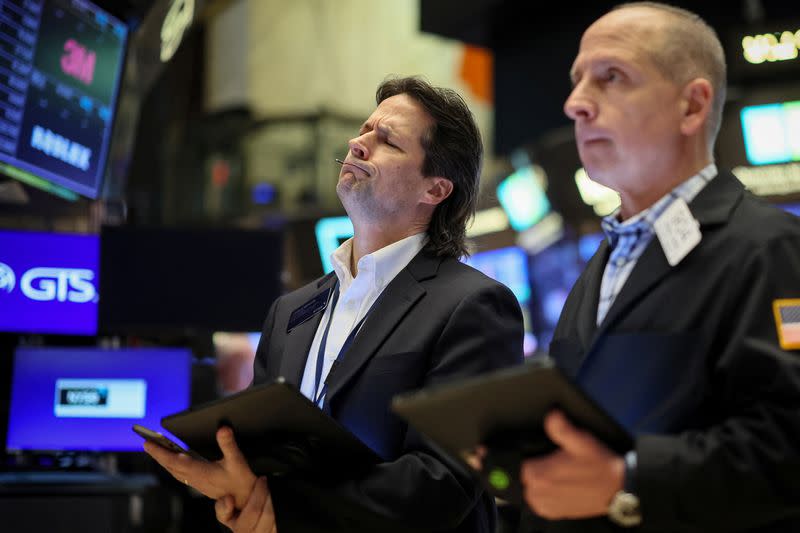 Traders work on the floor of the NYSE in New York