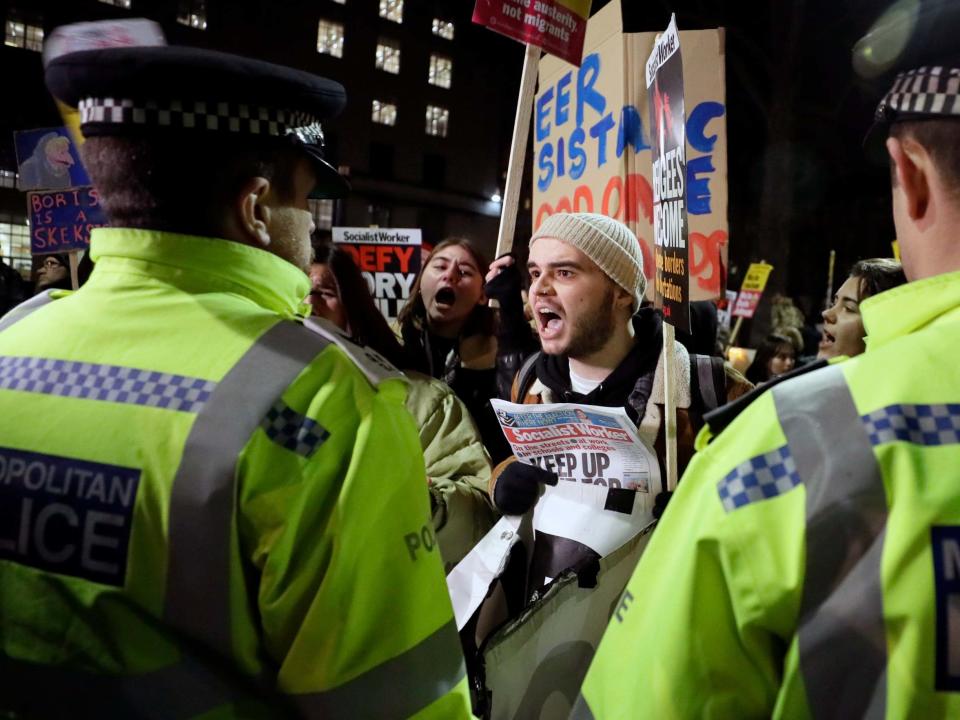 People attend an anti-Boris Johnson demonstration, in central London: AP