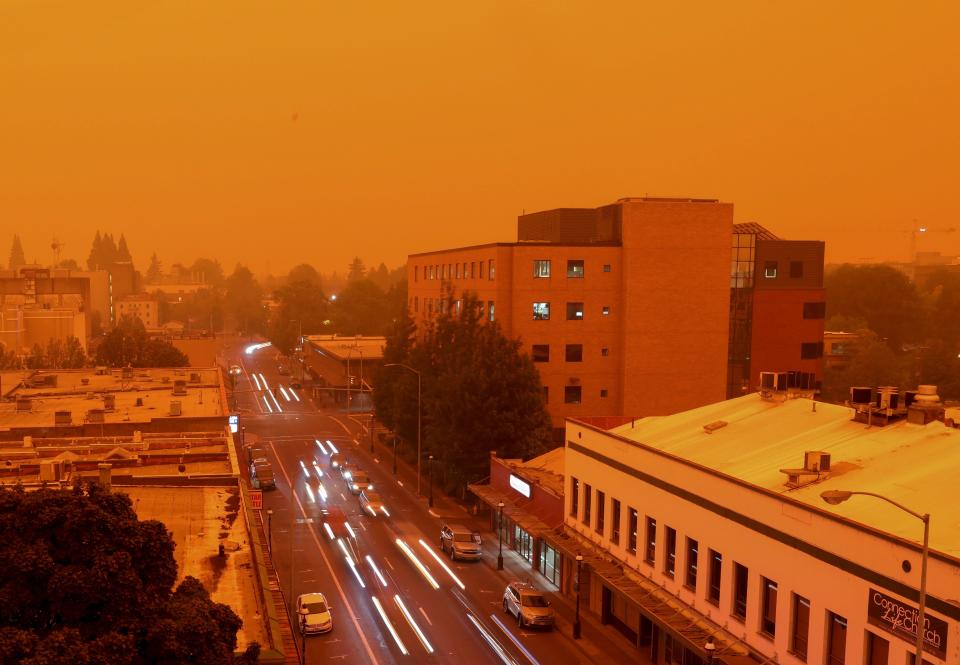In this Sept. 8, 2020, file photo, taken at 9:02 a.m., vehicles travel west on Ferry St. SE in downtown Salem. A combination of high winds and multiple wildfires brought smoke, poor air quality and low visibility to the Willamette Valley in September.