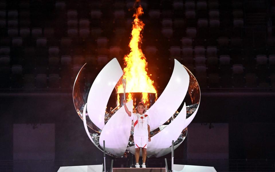 Japanese tennis player Naomi Osaka poses after lighting the Olympic cauldron - AFP