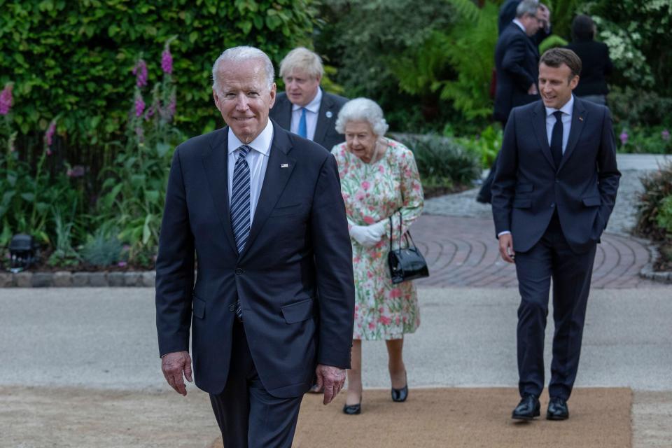 French President Emmanuel Macron, Queen Elizabeth II, British Prime Minister Boris Johnson and United States President Joe Biden arrive at a drinks reception for Queen Elizabeth II and G7 leaders at The Eden Project during the G7 Summit on June 11.