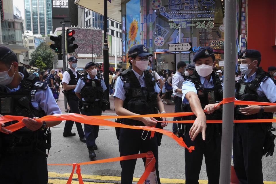 Police officers set up cordon line near the Hong Kong's Victoria Park, Saturday, June 4, 2022. Dozens of police officers patrolled Hong Kong's Victoria Park on Saturday after authorities for a second consecutive third banned public commemoration of the anniversary of the Tiananmen Square crackdown in 1989, amid a crackdown on dissent in the city. (AP Photo/Kin Cheung)