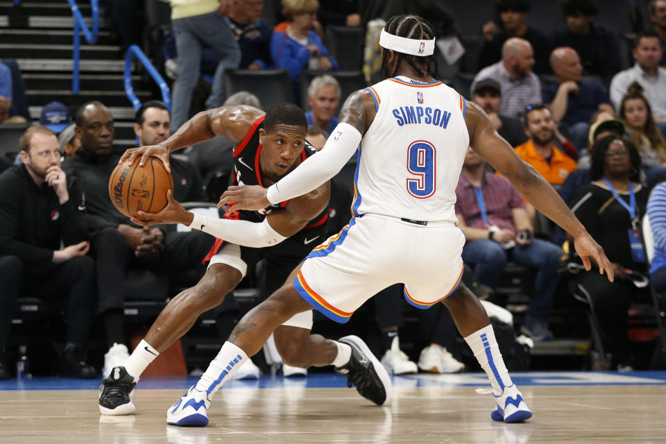 Portland Trail Blazers guard Kris Dunn (18) looks to make a move against Oklahoma City Thunder guard Zavier Simpson (9) during the first half of an NBA basketball game Tuesday, April 5, 2022, in Oklahoma City. (AP Photo/Garett Fisbeck)