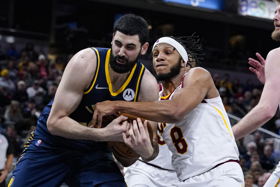 Indiana Pacers center Goga Bitadze (88) and Cleveland Cavaliers forward Lamar Stevens (8) tussle for control of the ball during the second half of an NBA basketball game in Indianapolis, Tuesday, March 8, 2022. The Cavaliers won 127-124. (AP Photo/Michael Conroy)