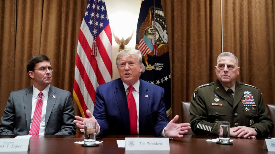 Flanked by Secretary of Defense Mark Esper, left, and Chairman of the Joint Chiefs Mark Milley, President Donald Trump meets with military leaders at the White House on October 7, 2019.  - Kevin Lamarque/Reuters