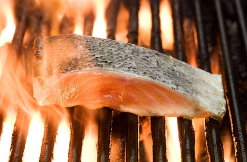 Put the salmon on the grill skin-side up