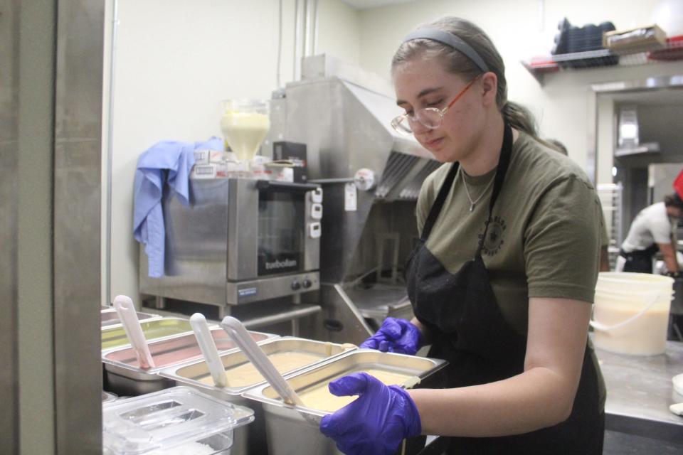 Parlor Doughnuts employee Mackenzie Haynes prepares doughnut glaze for the opening of the new shop at 120 Palafox Place in downtown Pensacola on Friday,  July 8, 2022.